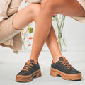 Unisex vegan low top shoes crafted from black Piñatex wearing shorts | NAE Footwear